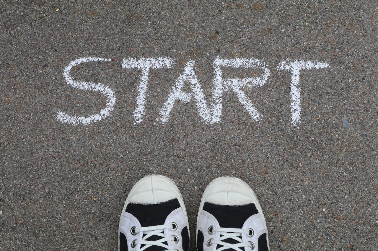 gallery-5 Close-up of sneakers and a 'START' chalk drawing on pavement, symbolizing new beginnings.